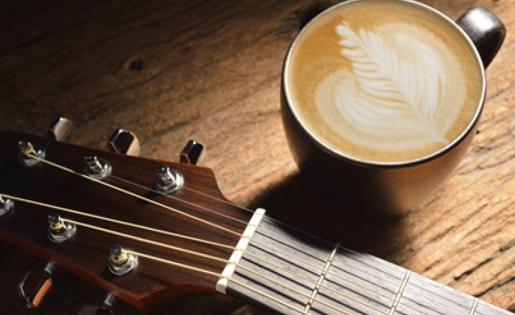 guitar near cup of coffee